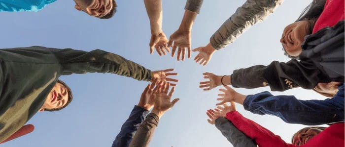 hands joining in teamwork for community