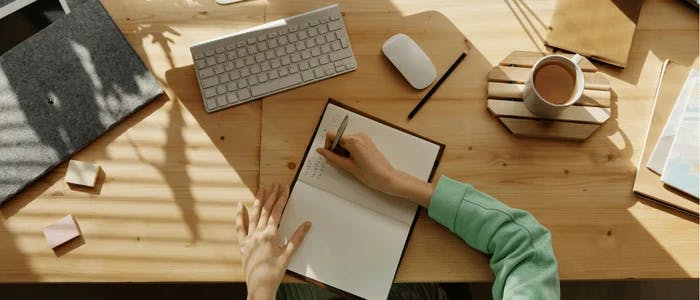 person planning community design strategy with a notebook and computer